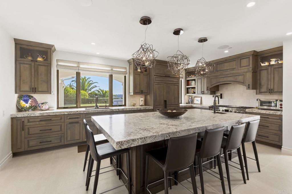 3226 Violet Ridge Encinitas, CA 92024 - Photo 6 of 54 a kitchen with a table and chairs in it