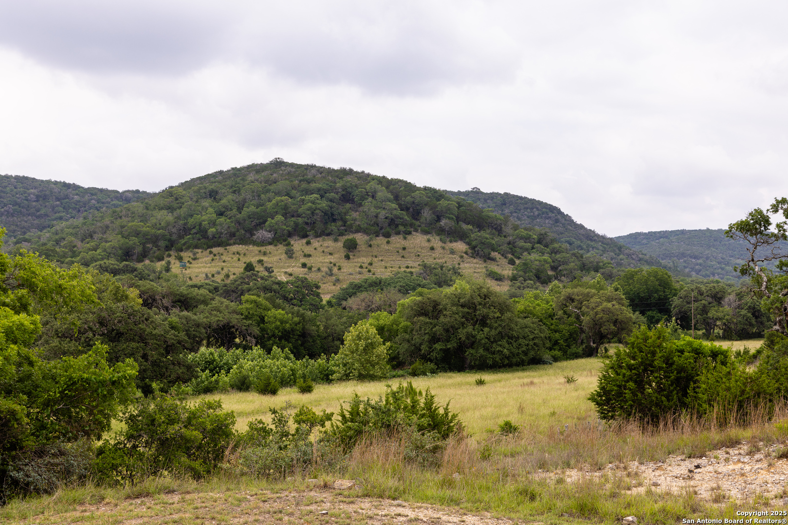 1616 Mickle Creek Road Medina, TX 78055 - Photo 7 of 18 a view of a lake with mountains in the background
