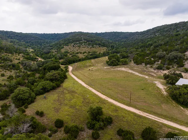 a view of a field with mountains in the background