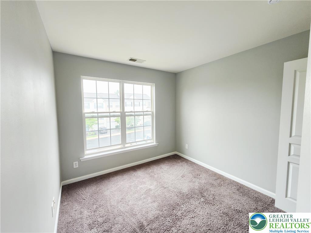 8513 Gateway Road Breinigsville, PA 18031 - Photo 40 of 45 A well-lit room offers comfort with plush carpeting and natural illumination.