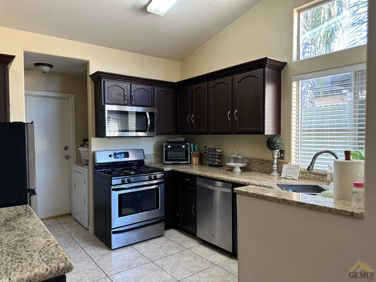 Undisclosed Address Bakersfield, CA 93313 - Photo 5 of 7 a kitchen with stainless steel appliances granite countertop a stove microwave and sink