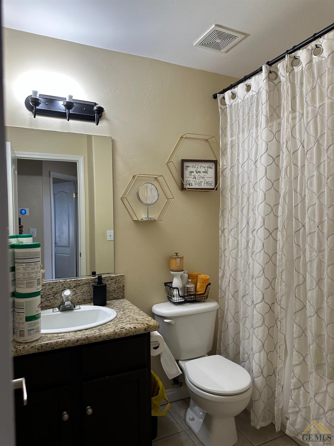 Undisclosed Address Bakersfield, CA 93313 - Photo 7 of 7 a bathroom with a granite countertop sink mirror vanity and toilet