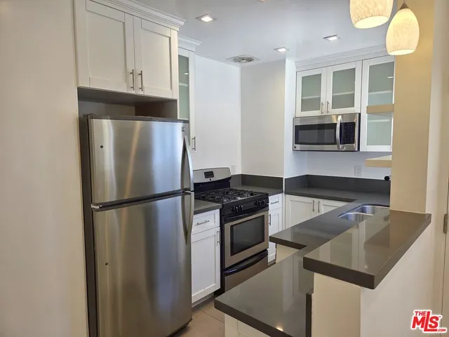 a kitchen with a refrigerator and a sink