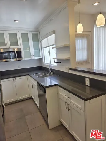 a kitchen that has a sink and a stove