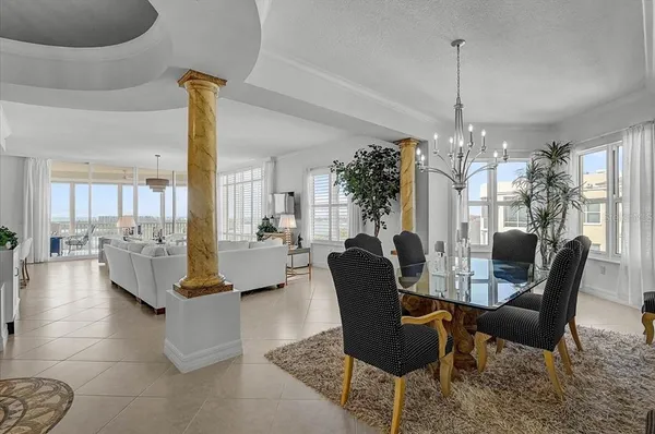 a living room with fireplace furniture and a large window