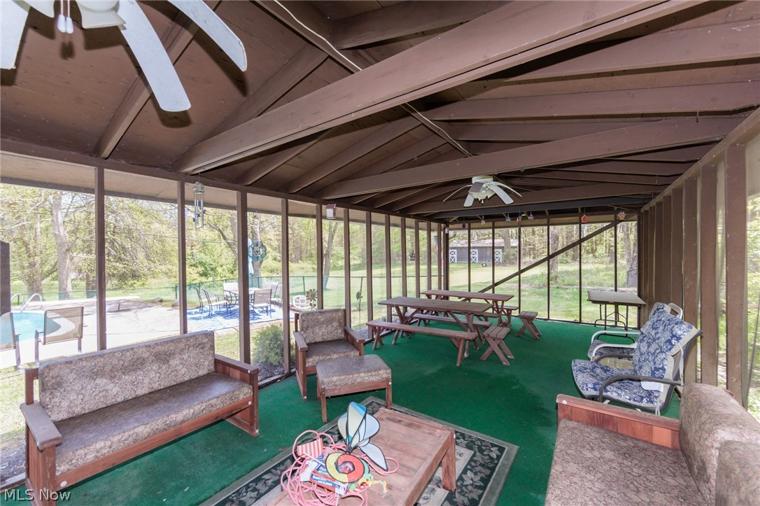 2170 Norton Road Stow, OH 44224 - Photo 14 of 48 Screened porch with a pitched roof featuring exposed wood beams and ceiling fans
