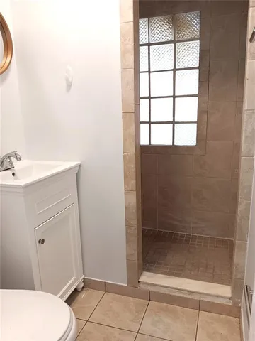 a bathroom with a shower and toilet