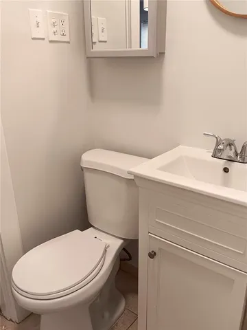 a white toilet sitting next to a bathroom sink