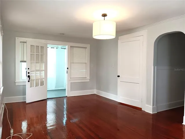 a view of a kitchen with wooden floor and electronic appliances