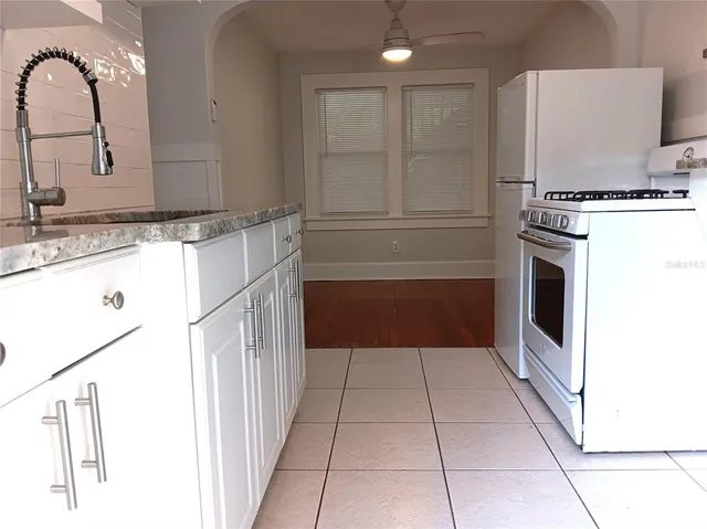 a kitchen with a sink a stove and cabinets