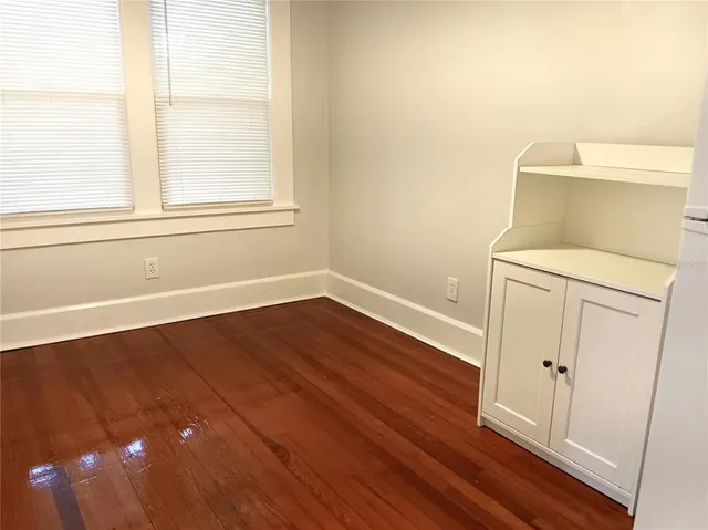 a view of a room with wooden floor and window