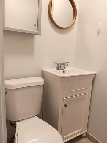 a white toilet sitting next to a bathroom sink