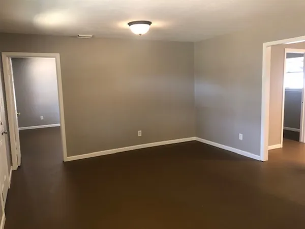 a view of an empty room with closet area