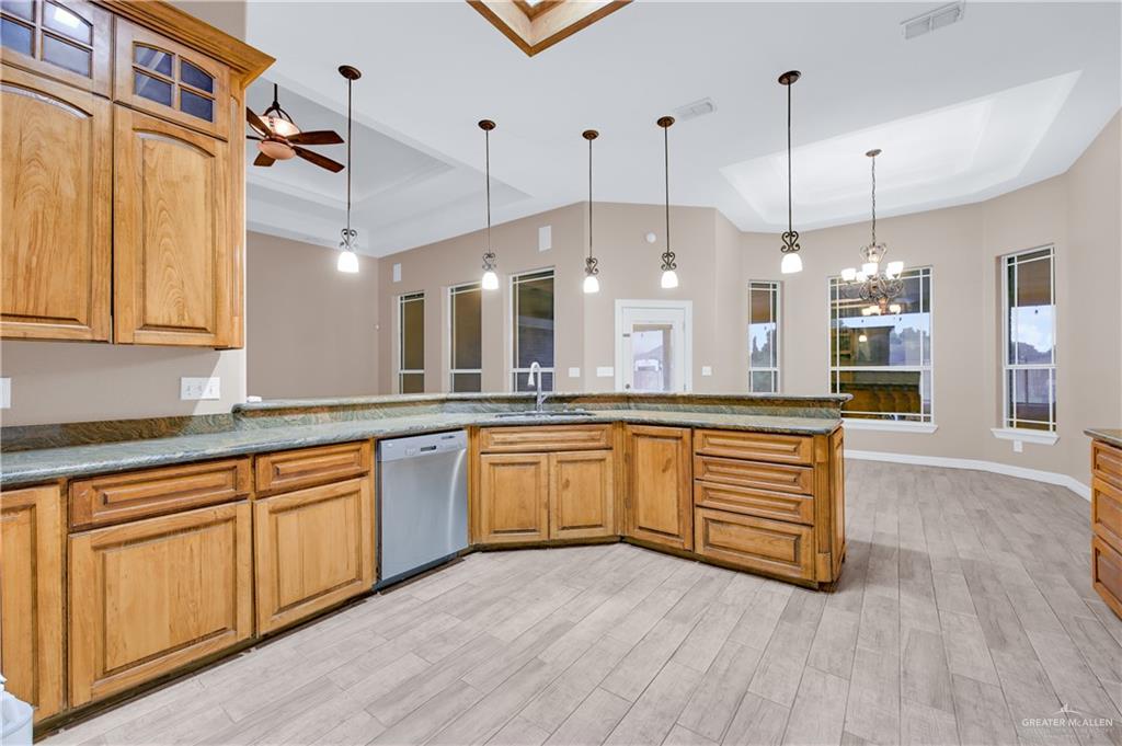 2005 Stuart Road Weslaco, TX 78599 - Photo 14 of 30 a large kitchen with stainless steel appliances granite countertop a stove a sink and a wooden floors