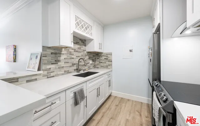 a kitchen with a stove and a sink