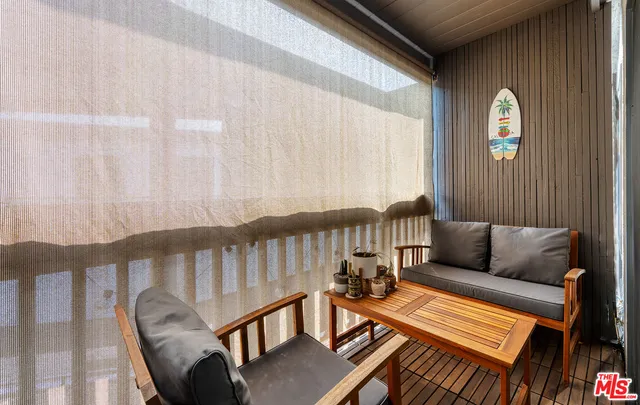 a balcony with furniture and a window