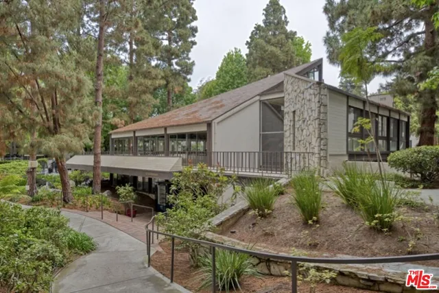 a backyard of a house with plants and outdoor seating