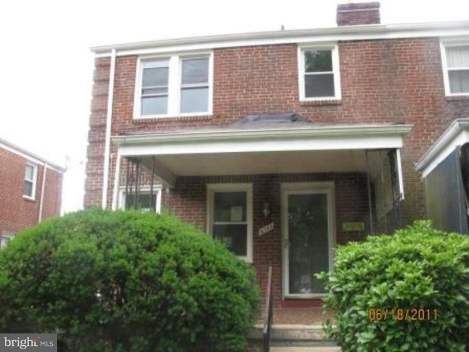 3733 Clarinth Road Baltimore, MD 21215 - Photo 1 of 5 front view of a brick house with a large windows
