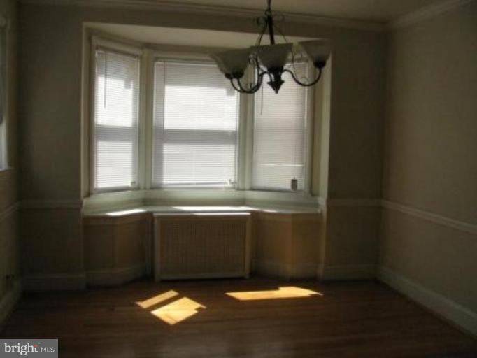 3733 Clarinth Road Baltimore, MD 21215 - Photo 2 of 5 a bathroom with a window and a shower