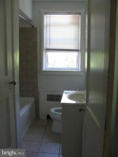 3733 Clarinth Road Baltimore, MD 21215 - Photo 5 of 5 a bathroom with a sink toilet and bathtub