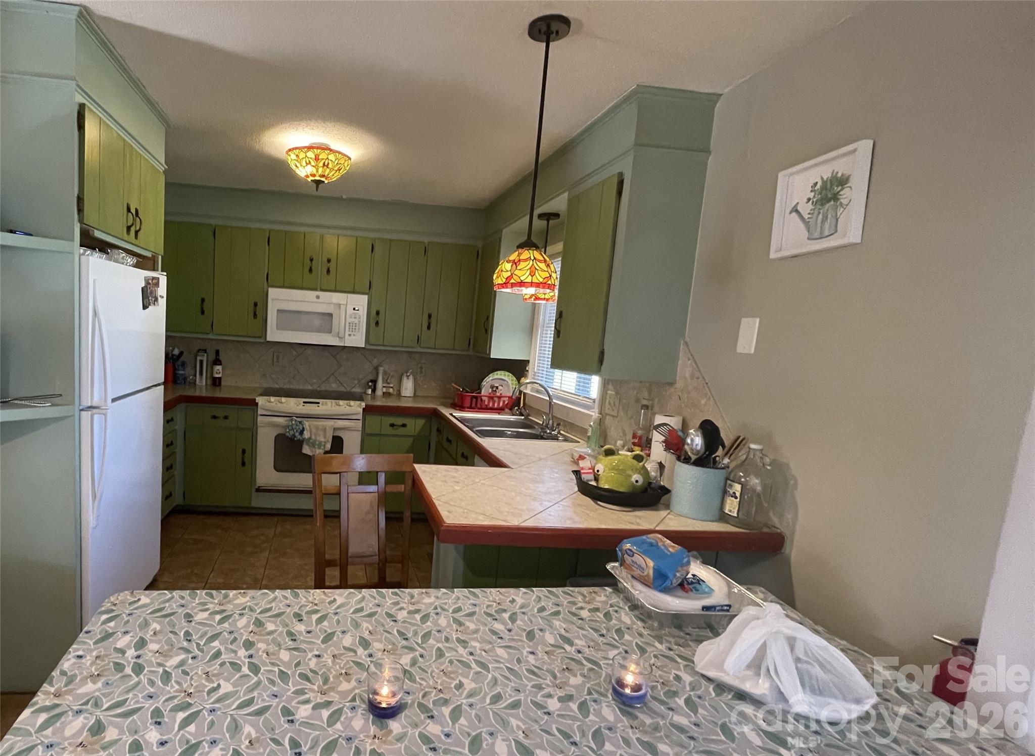 4907 Delmar Griffin Road Monroe, NC 28112 - Photo 8 of 25 a kitchen with a refrigerator and a stove top oven
