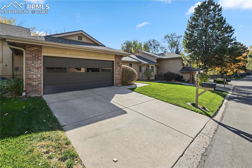 a front view of a house with a yard and garage