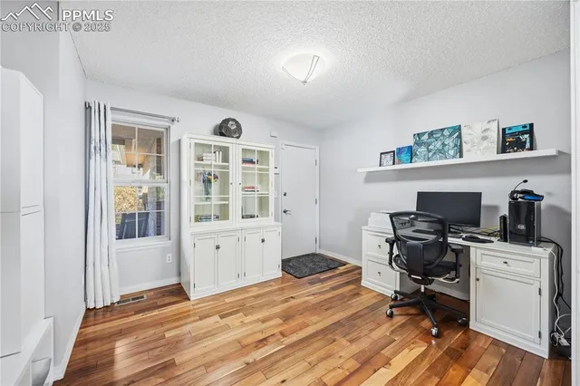 a workspace with furniture and wooden floor
