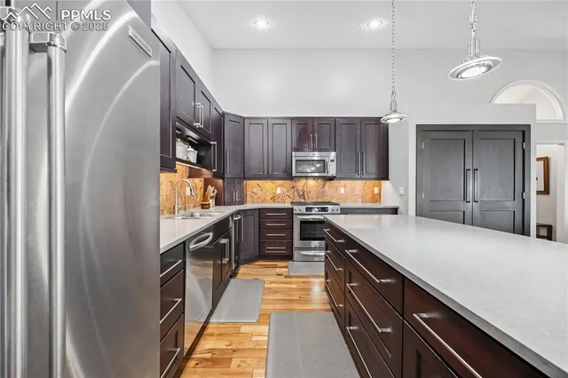a kitchen with stainless steel appliances granite countertop a sink and stove