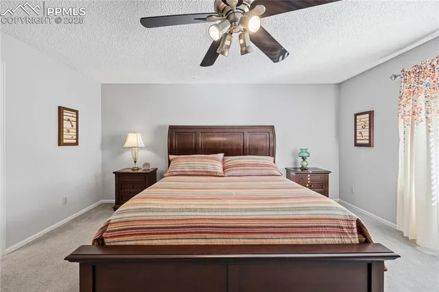 a bedroom with a bed and lamps