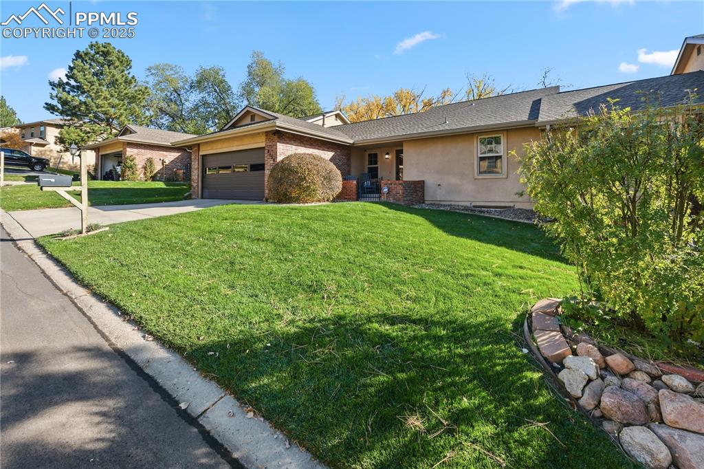 2135 Glenhill Road Colorado Springs, CO 80906 - Photo 2 of 50 a view of a house with backyard and garden