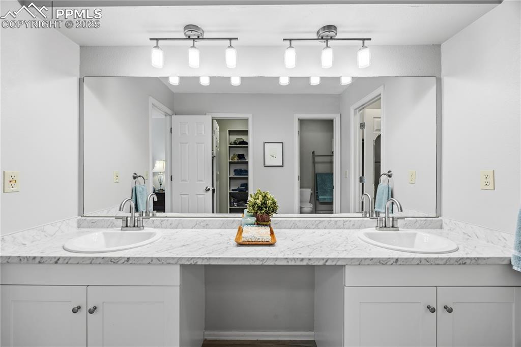 2135 Glenhill Road Colorado Springs, CO 80906 - Photo 24 of 50 a bathroom with a granite countertop sink and a mirror