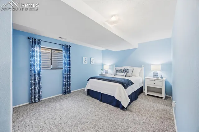 a spacious bedroom with a bed and closet