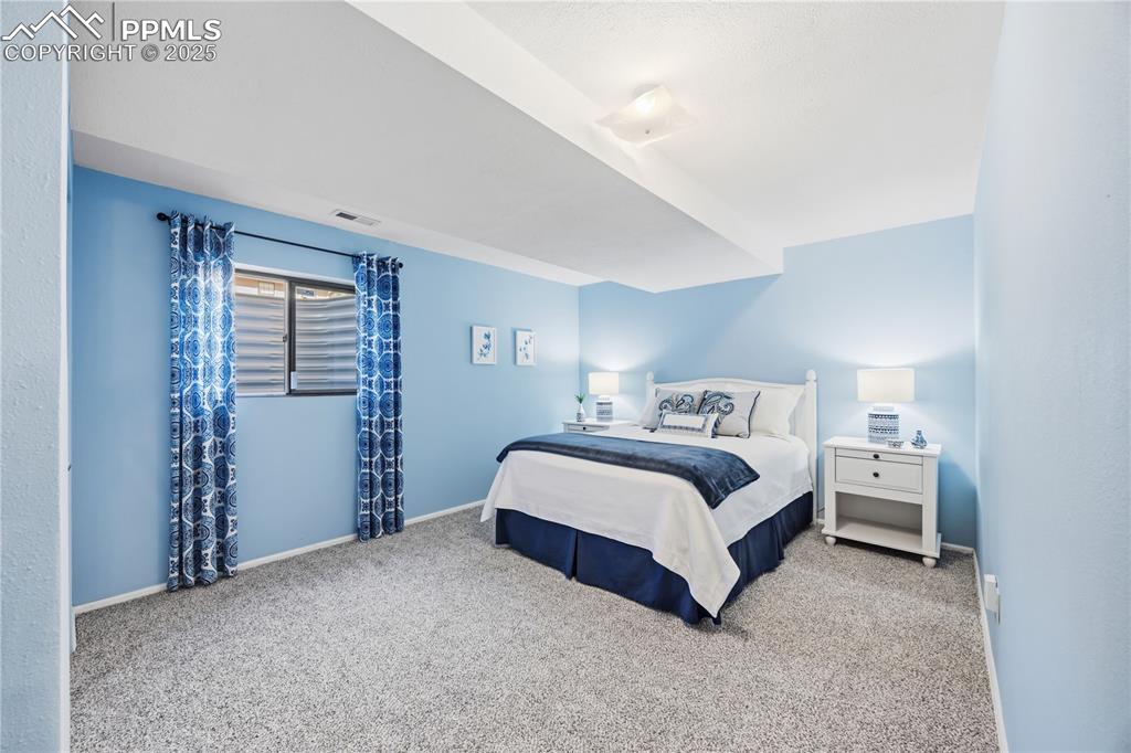 2135 Glenhill Road Colorado Springs, CO 80906 - Photo 32 of 50 a spacious bedroom with a bed and closet