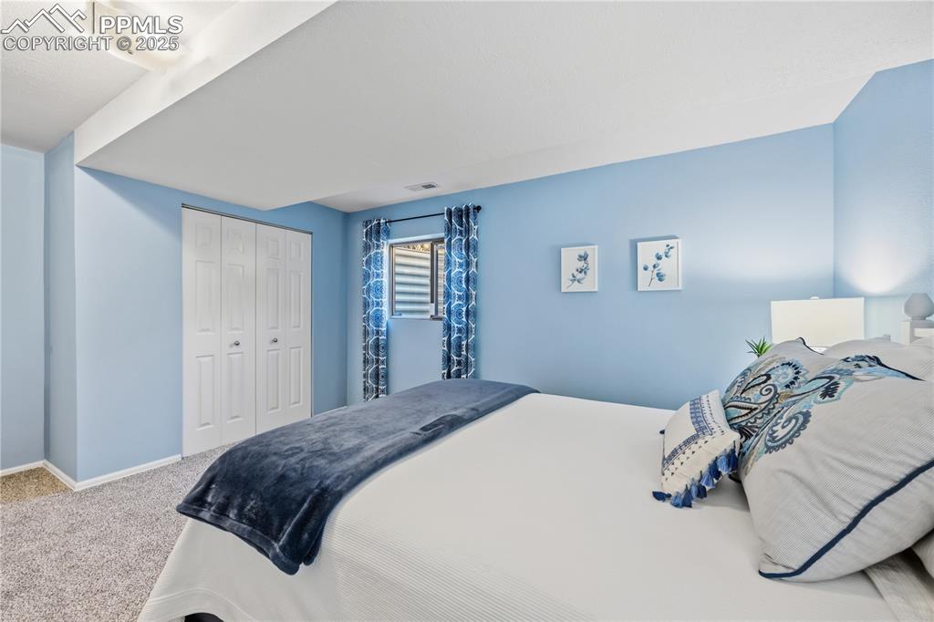 2135 Glenhill Road Colorado Springs, CO 80906 - Photo 33 of 50 a bedroom with a bed and a window