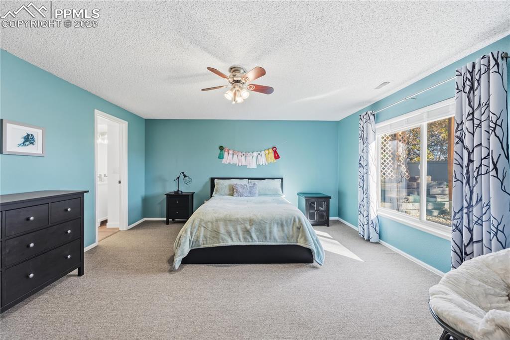 2135 Glenhill Road Colorado Springs, CO 80906 - Photo 39 of 50 a spacious bedroom with a bed and a large window