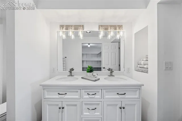 a bathroom with a sink double vanity and a mirror