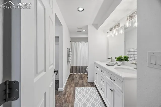 a spacious bathroom with a double vanity sink and a mirror