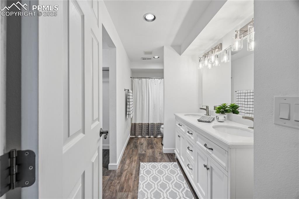 2135 Glenhill Road Colorado Springs, CO 80906 - Photo 46 of 50 a spacious bathroom with a double vanity sink and a mirror