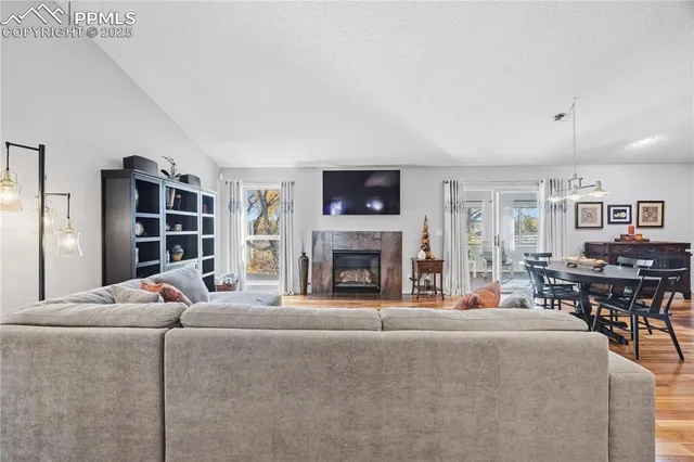 a living room with furniture a fireplace and a flat screen tv