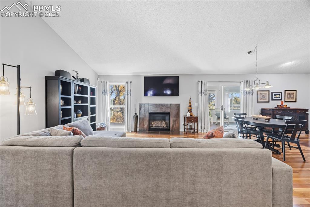 2135 Glenhill Road Colorado Springs, CO 80906 - Photo 8 of 50 a living room with furniture a fireplace and a flat screen tv