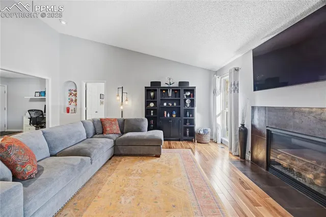 a living room with furniture a fireplace and a flat screen tv