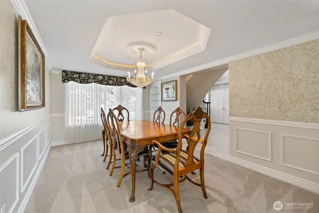 a view of a dining room with furniture and chandelier