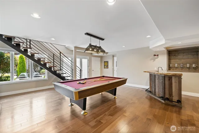 a room with furniture pool table and windows