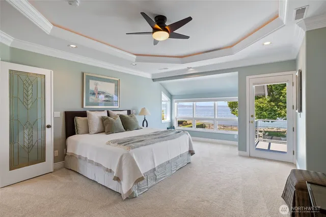 a spacious bedroom with a bed a table and a large window