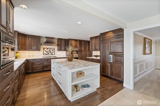 a kitchen with stainless steel appliances granite countertop a stove oven and a refrigerator