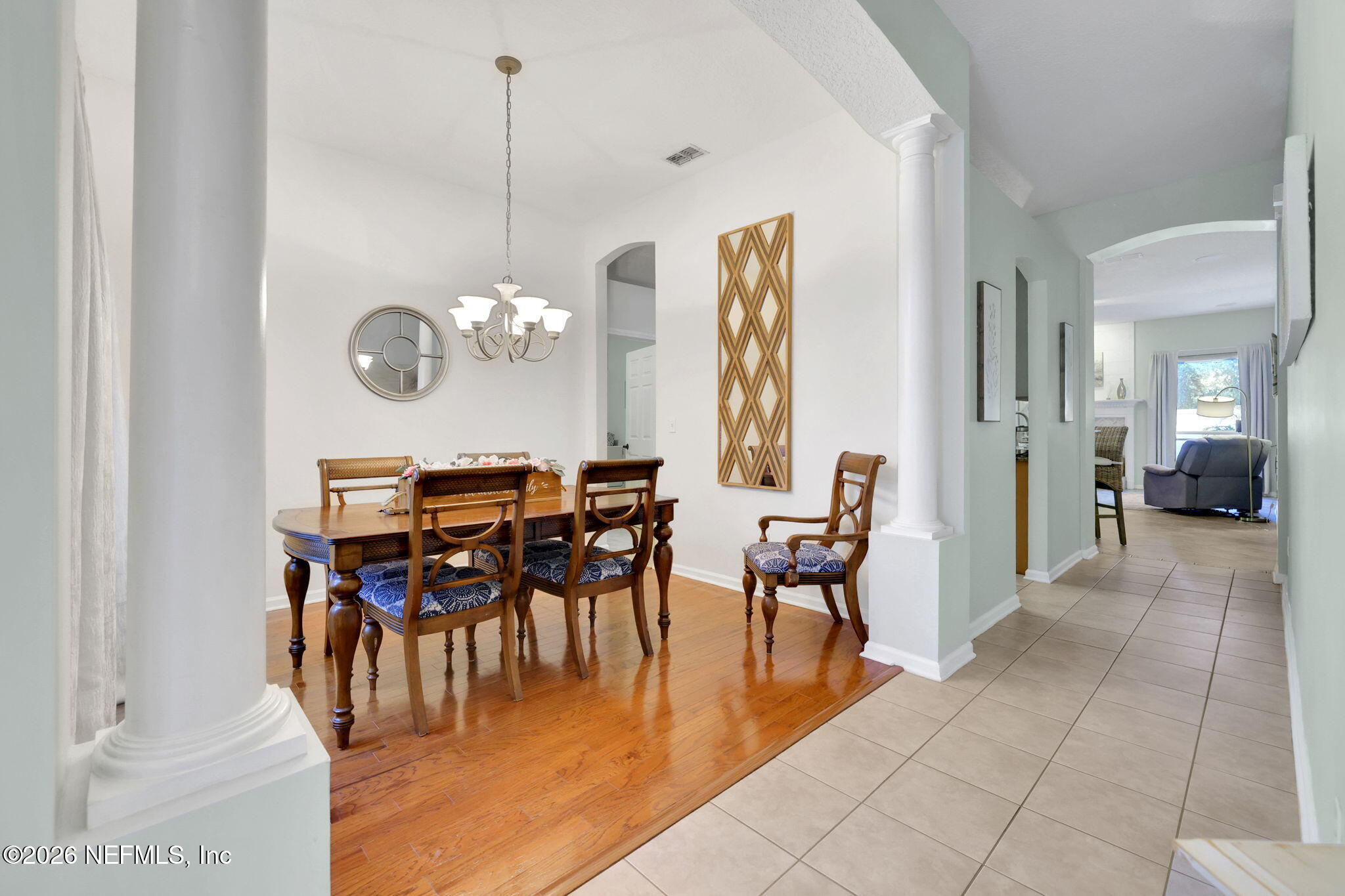 4320 Rye Court St. Johns, FL 32259 - Photo 8 of 60 a view of a dining room and livingroom with furniture wooden floor a chandelier