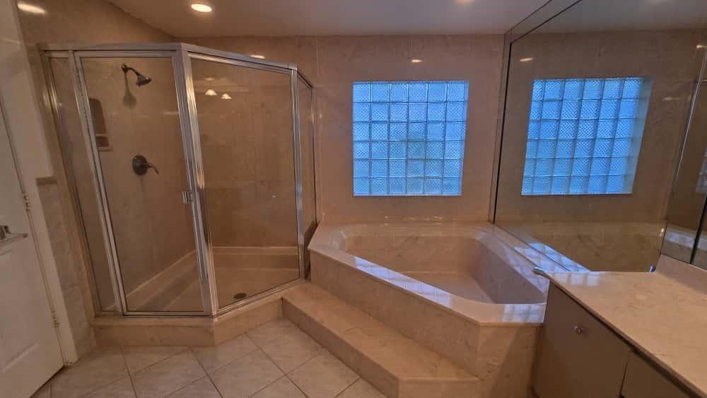 20167 Back 9 Drive Boca Raton, FL 33498 - Photo 13 of 28 a bathroom with a tub and shower