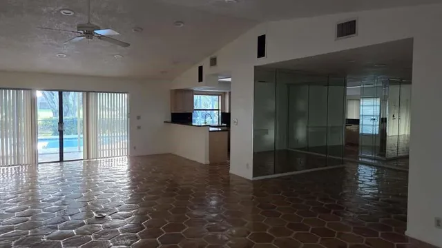 a view of a patio with couches table and chairs and potted plants