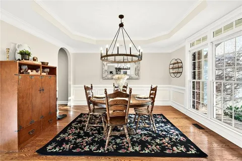 a view of a dining room with furniture and wooden floor