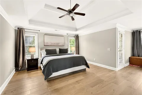 a spacious bedroom with a bed and large windows